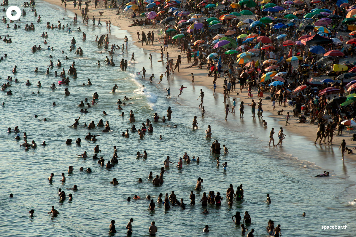 ภาพถ่ายทางอากาศเผยให้เห็นผู้คนกำลังเพลิดเพลินผ่อนคลายกับการเล่นน้ำทะเลที่ชายหาดเรเซอีโอ โดส บันเดรันเตส (Recreio dos Bandeirantes) กันอย่างเนืองแน่น เมื่อวันที่ 17 มีนาคม 2024 (Photo by TERCIO TEIXEIRA / AFP)